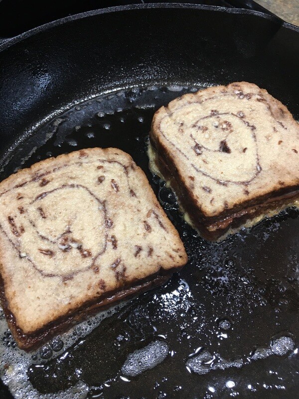 nutella french toast cooking in cast iron skillet