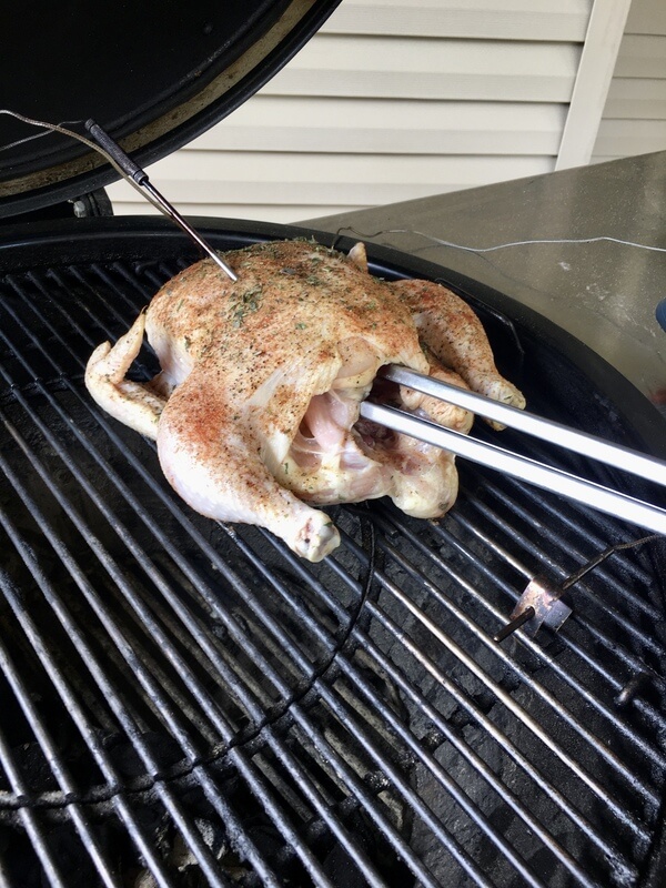 whole chicken on a charcoal grill