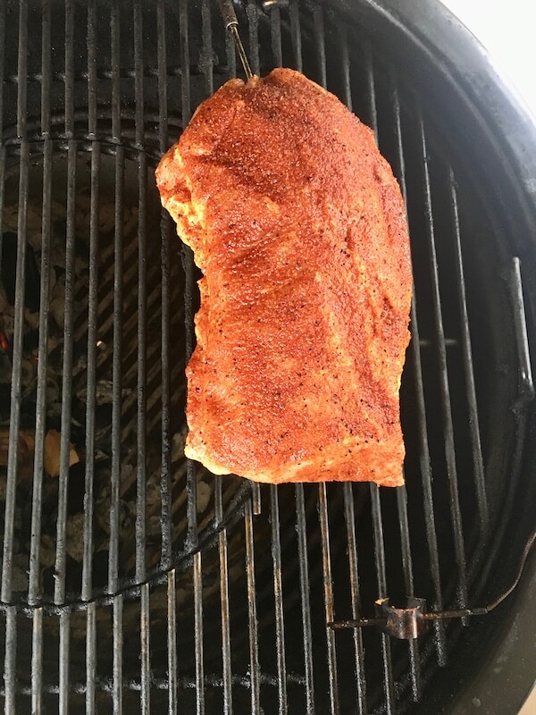 uncooked pork loin on a charcoal grill