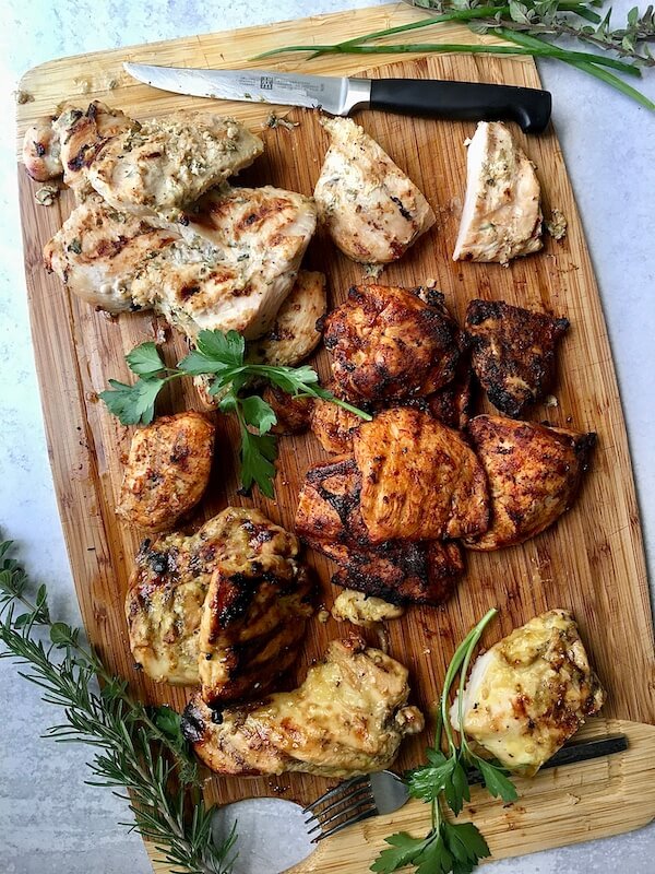 grilled chicken breasts on a cutting board