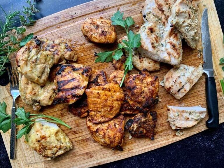 charcoal grilled chicken breasts on a cutting board