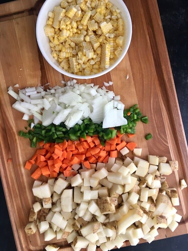 diced onions, carrots, potatoes, and green peppers with corn
