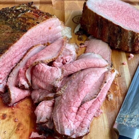 smoked beef roast sliced thin on a cutting board