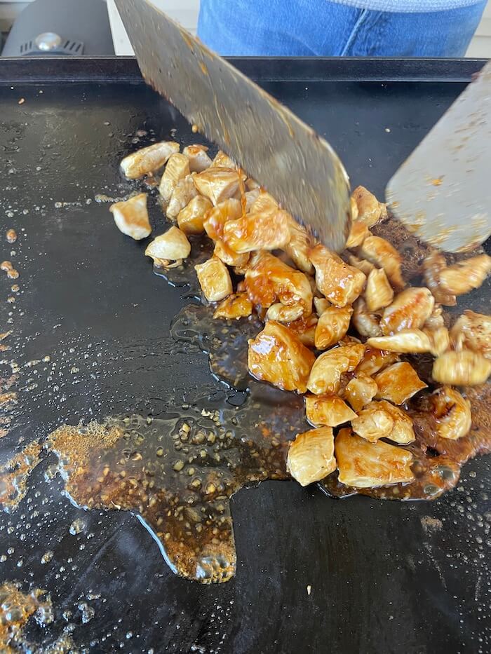 cooking chicken teriyaki on a griddle