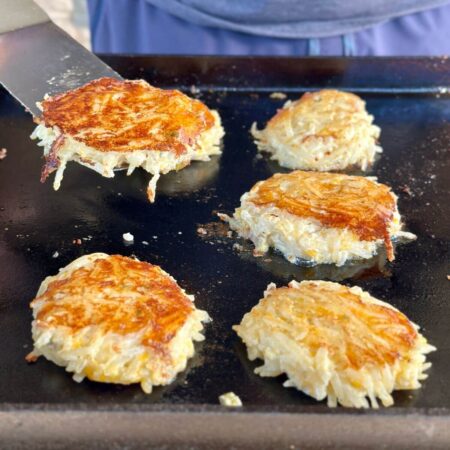 cooking hash brown casserole cakes on a Blackstone griddle