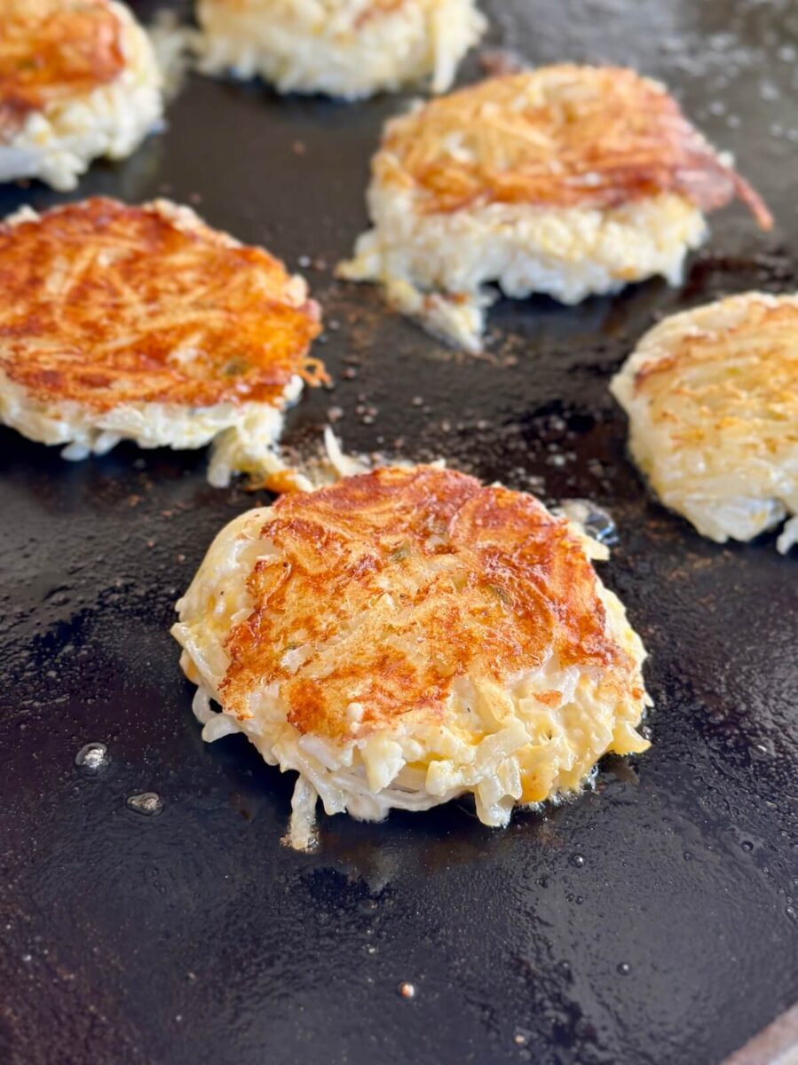 cooking hash brown casserole cakes on a griddle