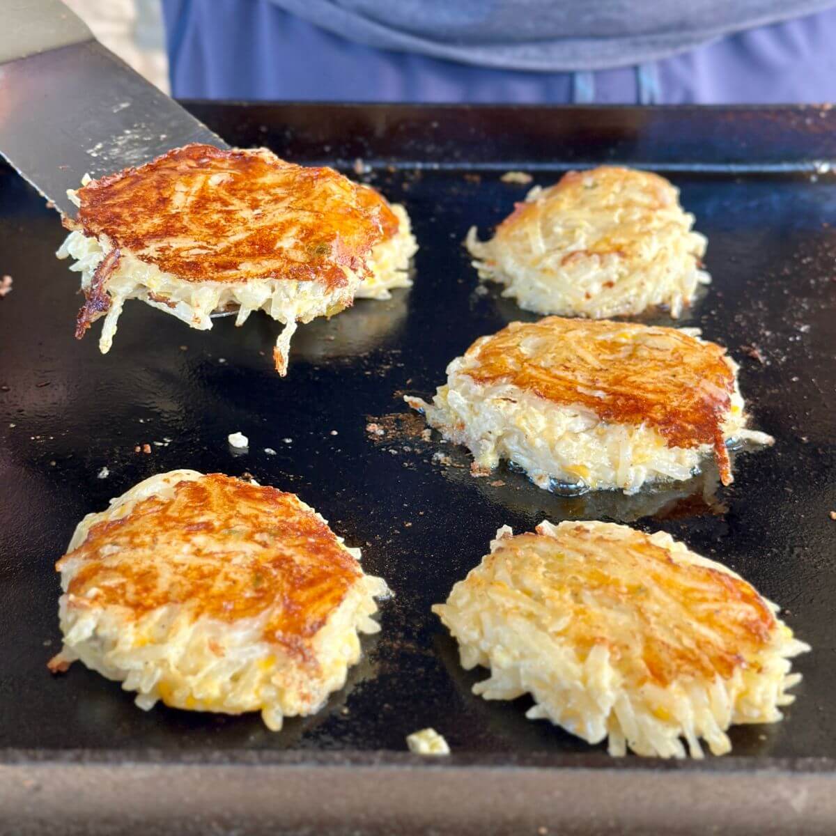 cooking hash brown casserole cakes on a Blackstone griddle