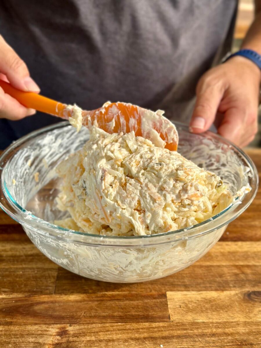 mixing hashbrown casserole mix in a bowl