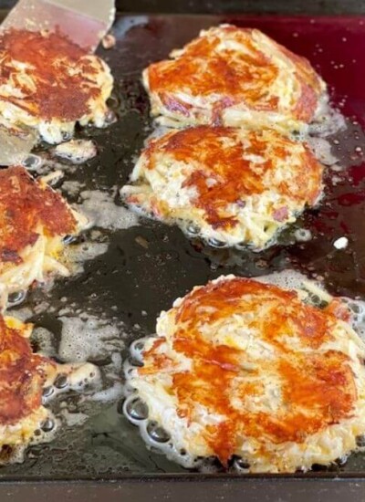 hashbrown casserole cooking on a flat top grill
