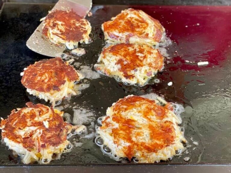 hashbrown casserole cooking on a flat top grill