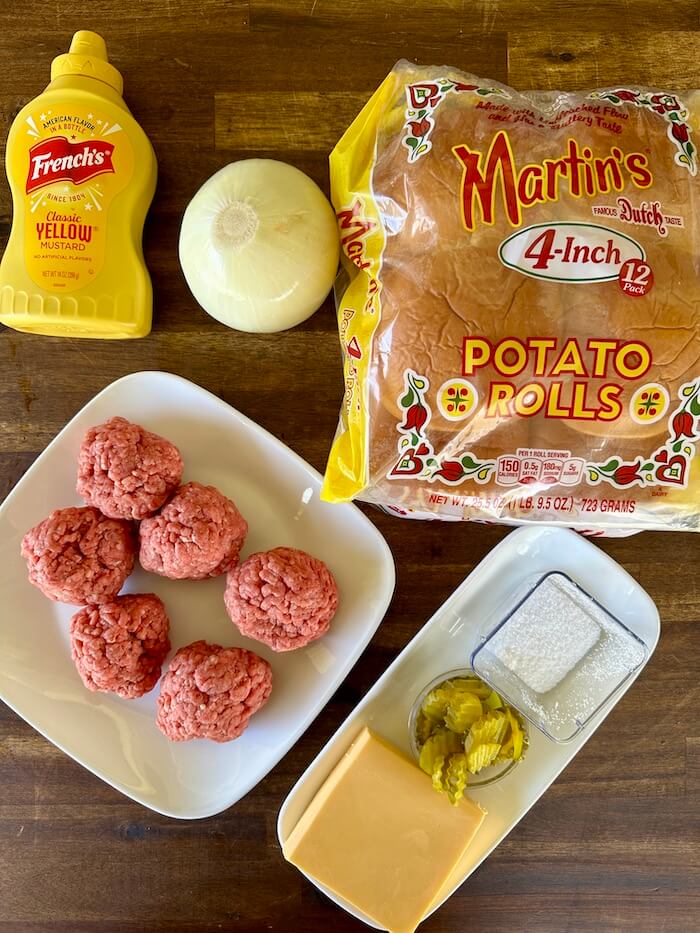ground beef balls, onion, American cheese, hamburger buns, and pickles