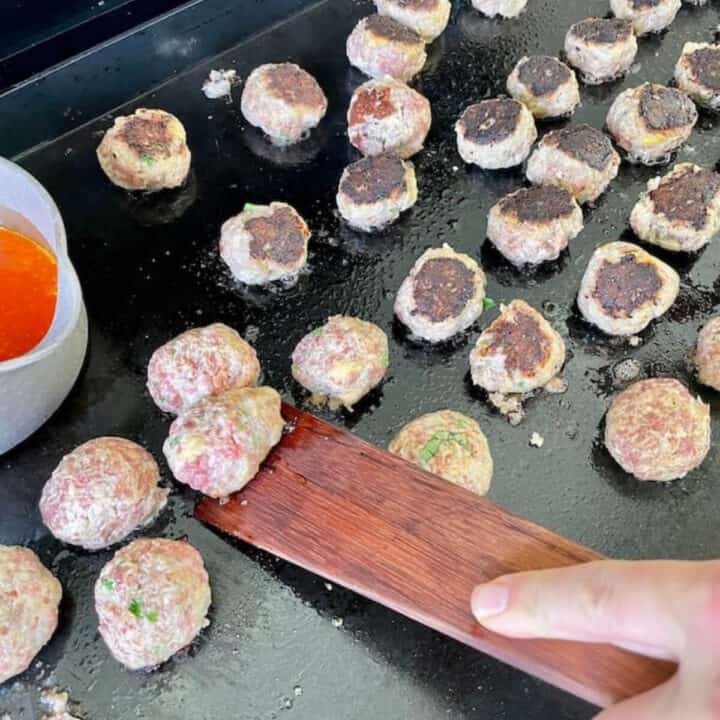 cooking homemade meatballs on the outdoor griddle