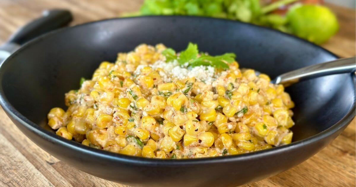 Mexican street corn in a bowl with cilantro and Cotija cheese