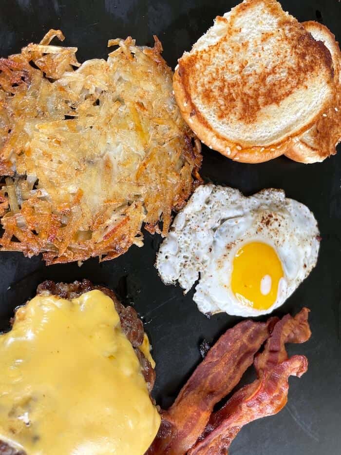 breakfast burger, hash browns, over easy egg, bacon, and hamburger bun