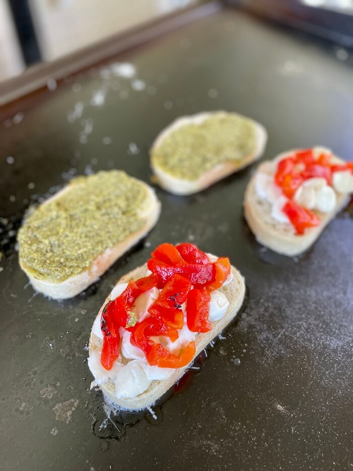 Caprese sandwich being made on a flat top grill