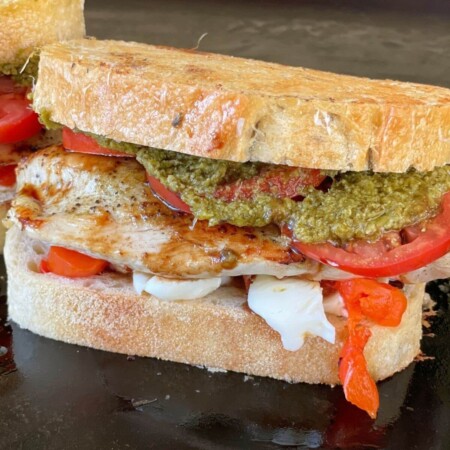 chicken caprese sandwich on a flat top grill