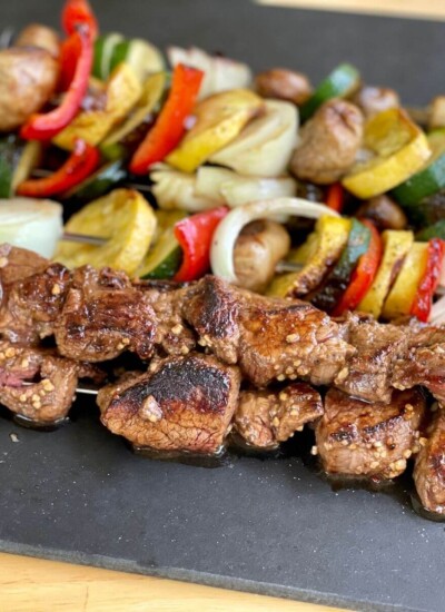 steak and vegetable kebabs cooked on a griddle