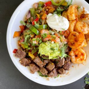 low carb burrito bowl made with steak, shrimp, and cauliflower rice