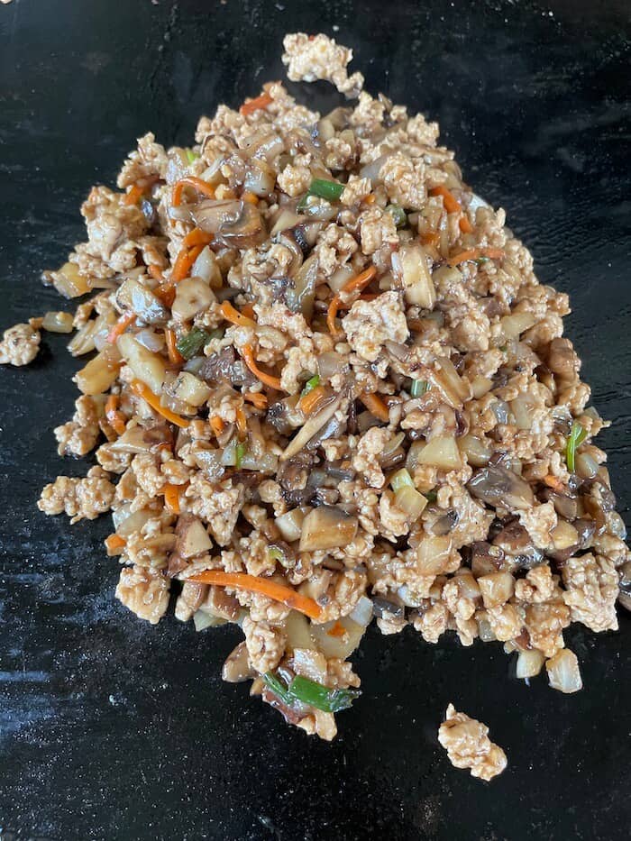 ground chicken lettuce wrap mixture on a griddle