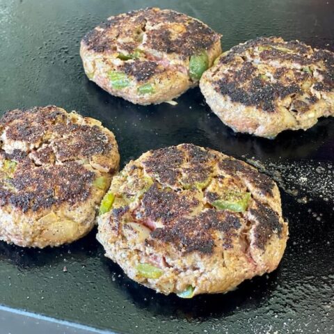 meatloaf patties cooking on a griddle