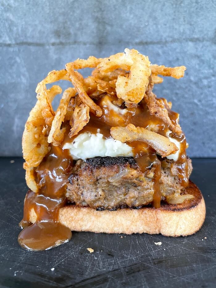 open faced meatloaf sandwich with mashed potatoes and gravy