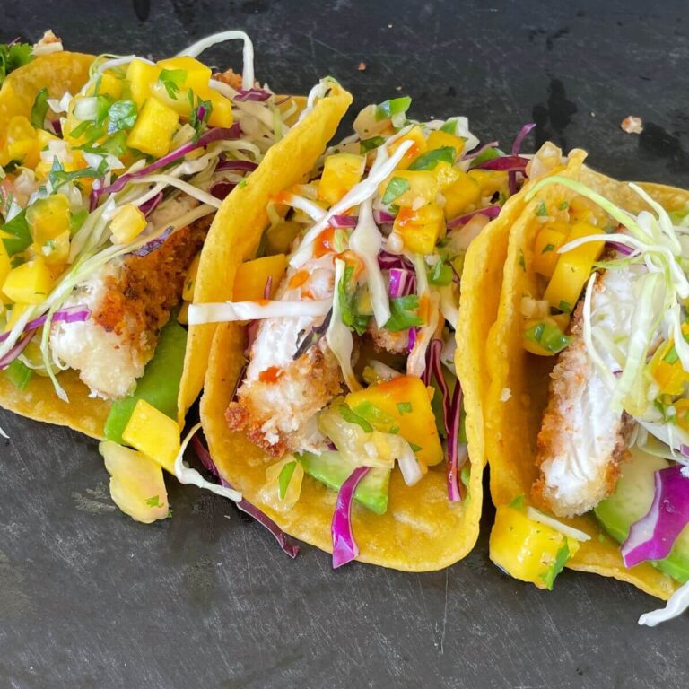 fish tacos with mango pico de gallo on corn tortillas