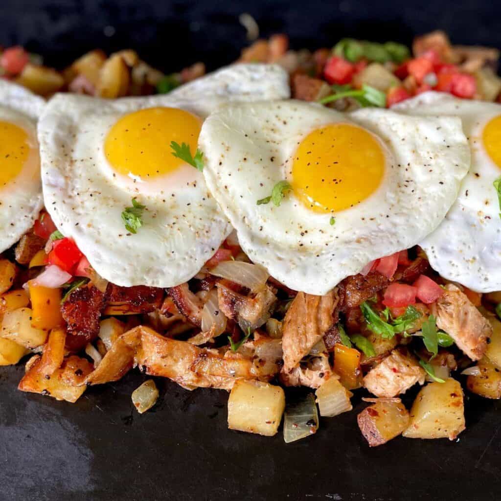 breakfast hash with peppers, onions, potatoes, brisket, and eggs