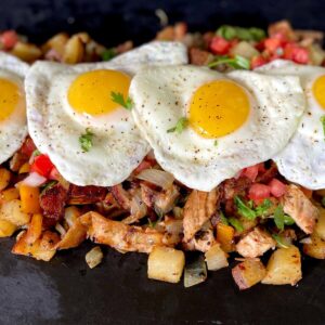 breakfast hash with peppers, onions, potatoes, brisket, and eggs