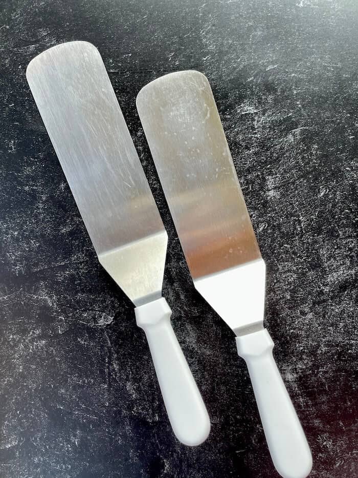 two white handled spatulas for the griddle