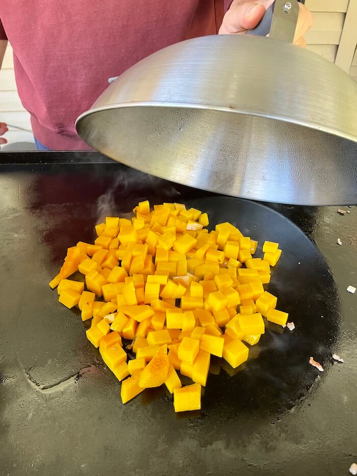 butternut squash cooking on a blackstone griddle