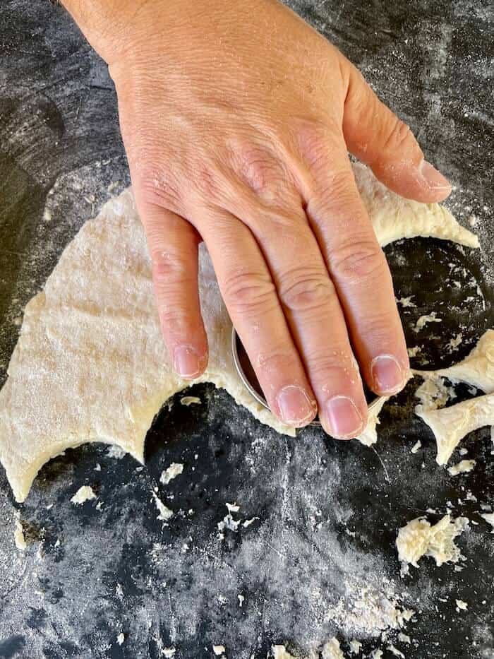 cutting biscuit dough with a biscuit cutter