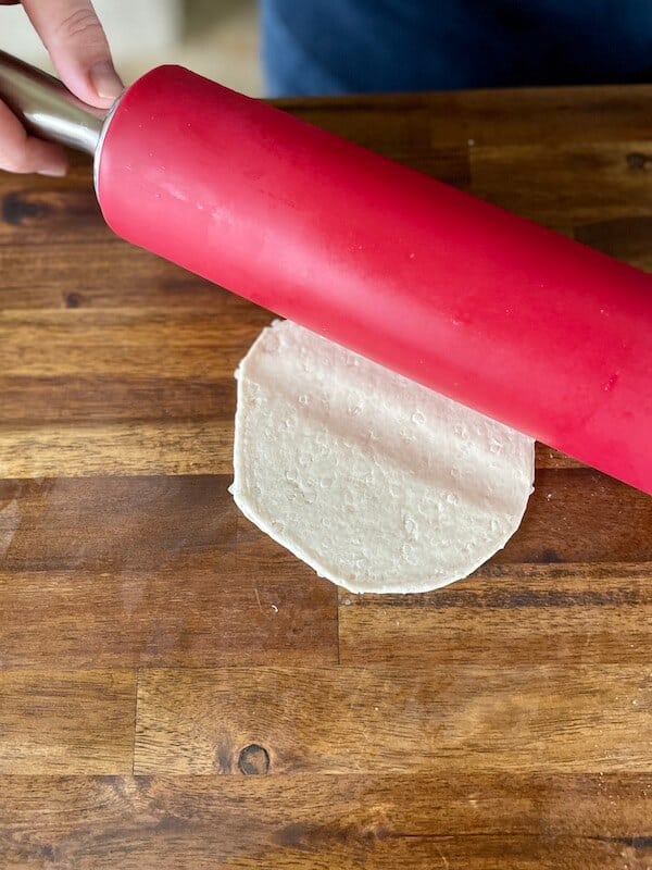 using a rolling pin to roll out Pillsbury grands biscuits