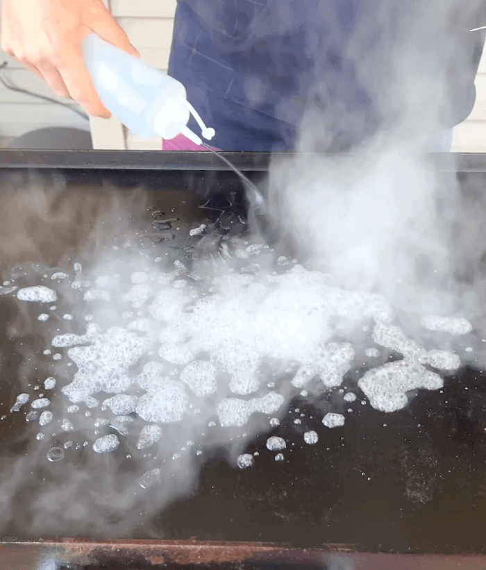 squirting water onto a blackstone griddle