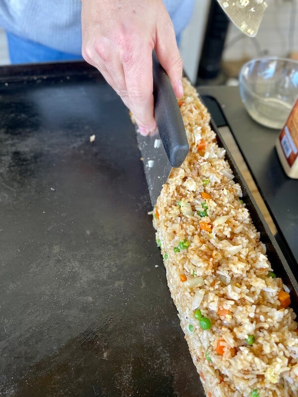 fried rice on the side of a blackstone griddle