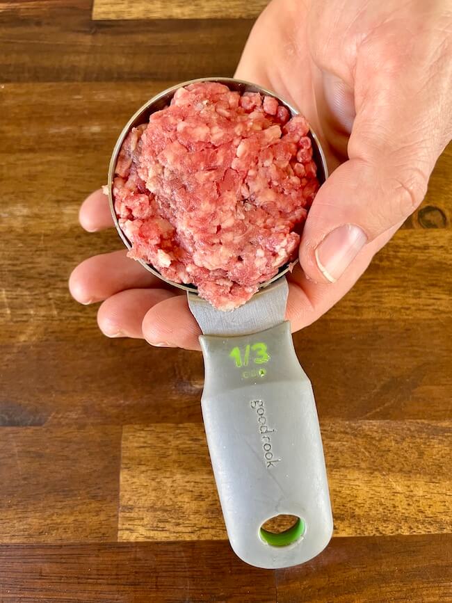 ground beef in a 1/3 cup measuring cup
