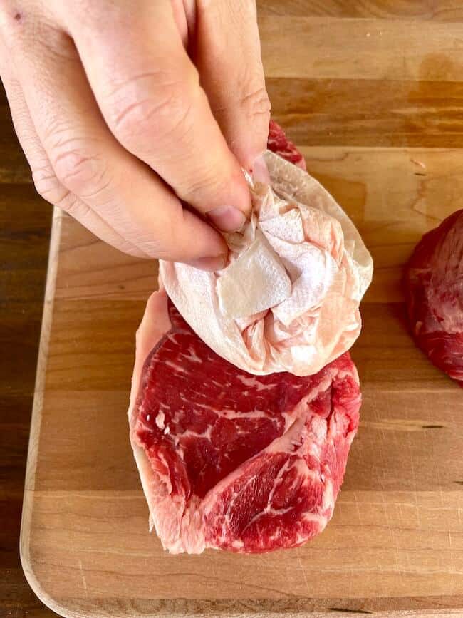 patting a steak dry with paper towels