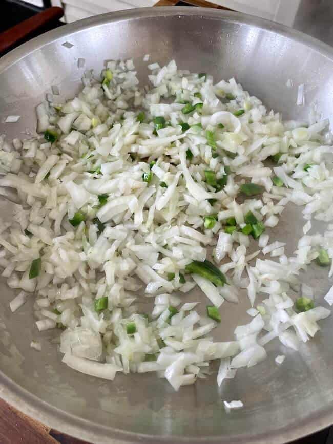 diced onions and jalapenos cooking in a skillet