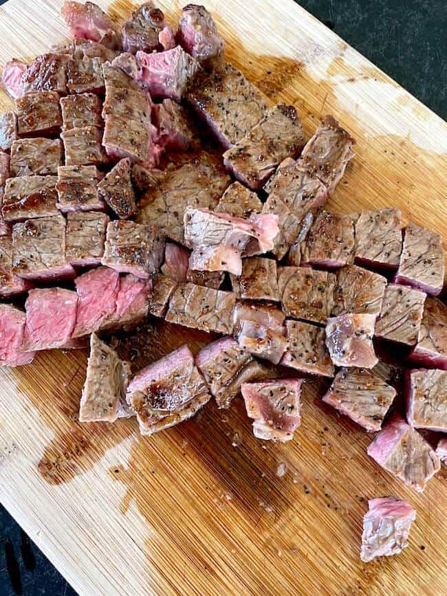 cut strip steak on a cutting board
