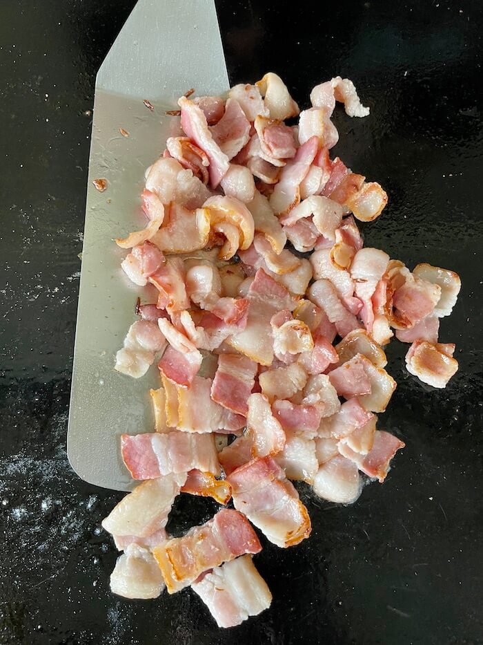 cut bacon cooking on the blackstone griddle