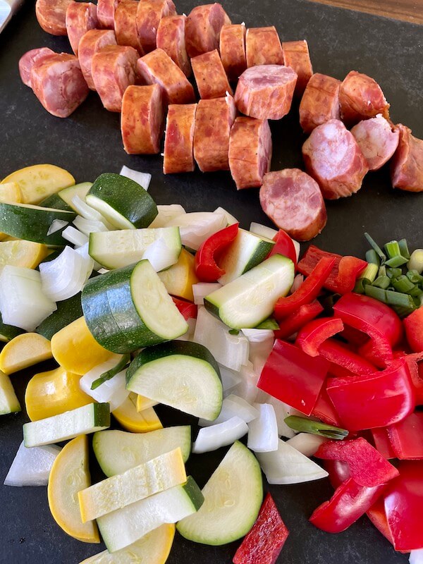 cut vegetables and andouille sausage