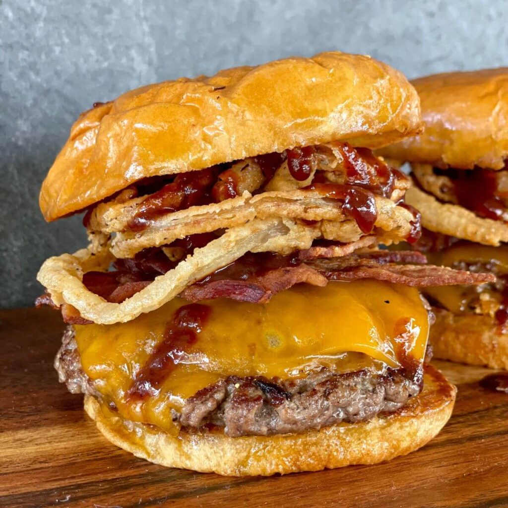 western burger with bacon, cheese, barbecue sauce, and fried onion rings