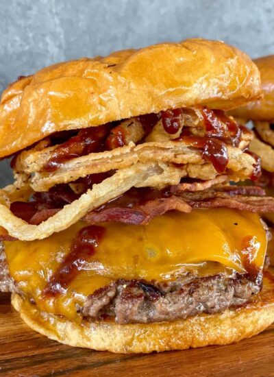 western burger with bacon, cheese, barbecue sauce, and fried onion rings