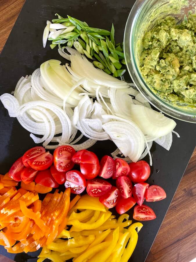 sliced bell peppers, onions and tomatoes and homemade guacamole