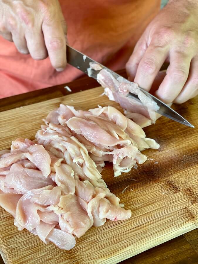 cutting chicken breast into thin strips