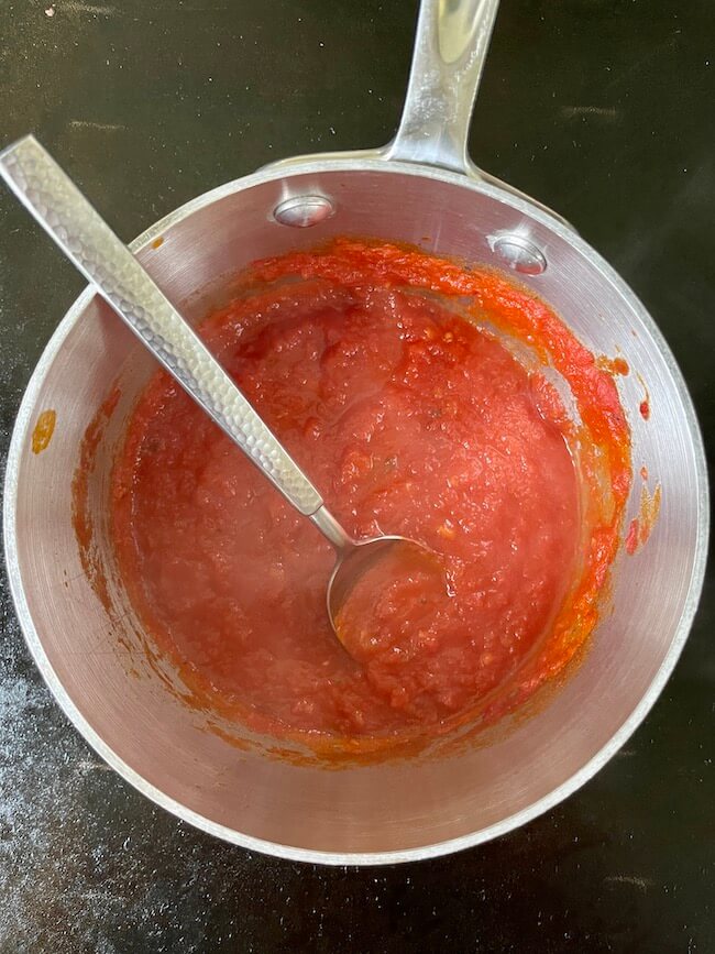 marinara sauce in a saucepan on a griddle