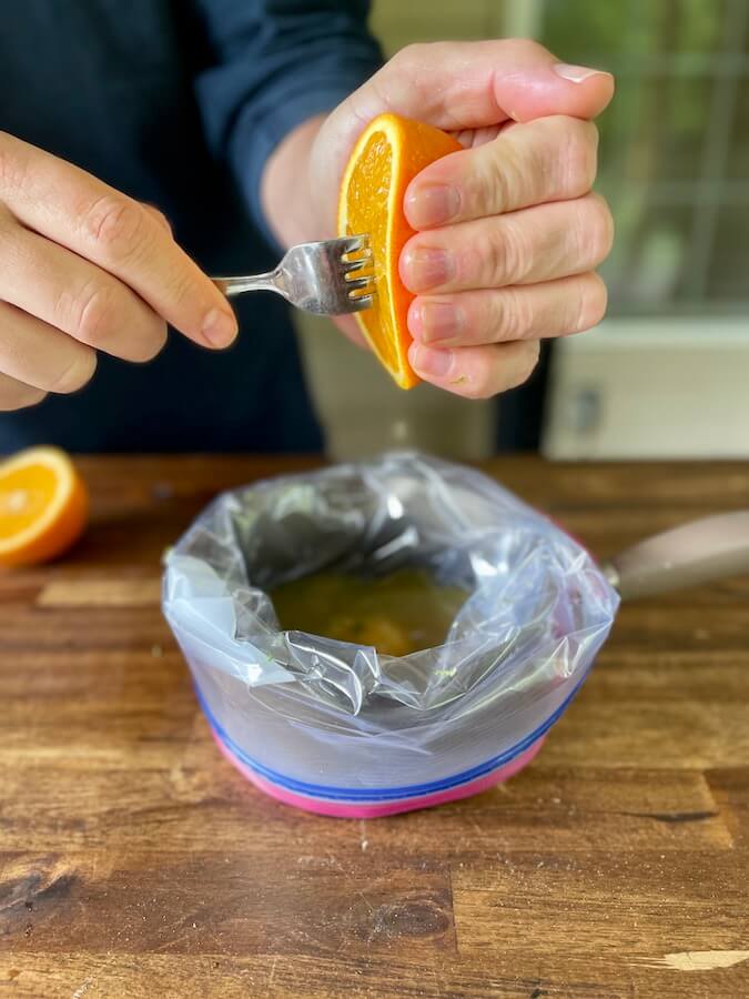 adding orange juice to a steak fajita marinade