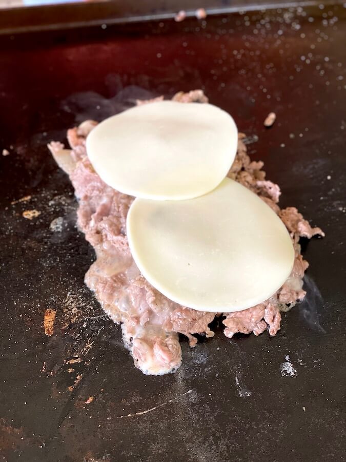 cooking cheesesteak on a griddle