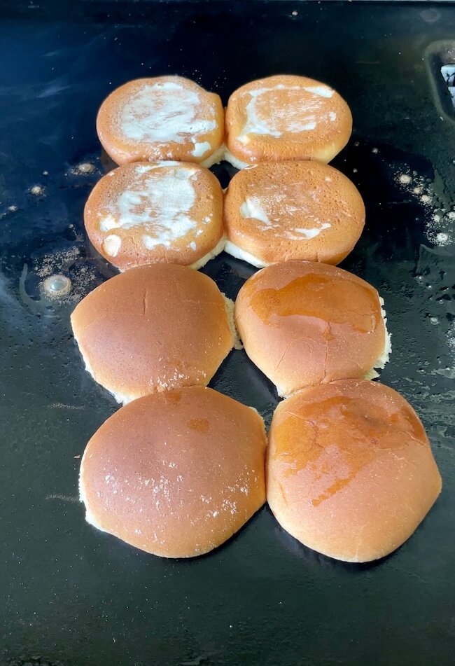 Hawaiian slider buns toasting on a griddle