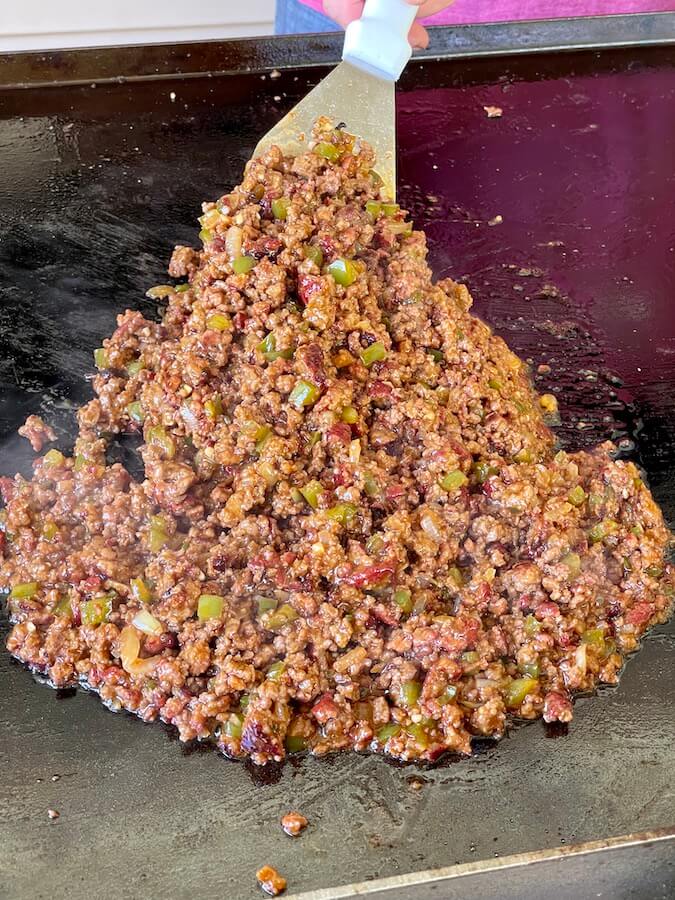smoked sloppy joes meat mixture on a griddle
