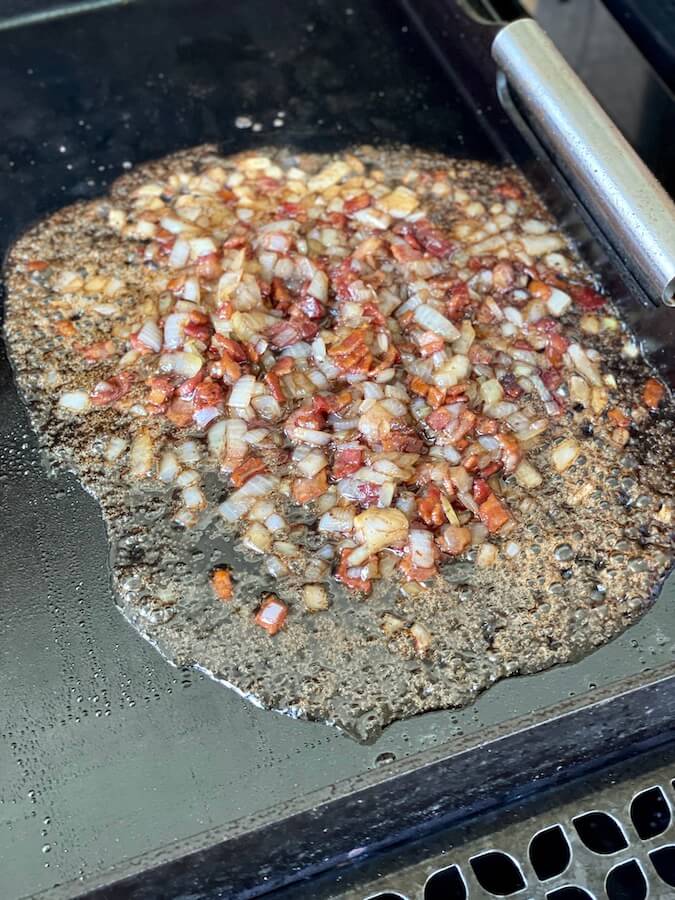 bacon onion jam cooking on a griddle